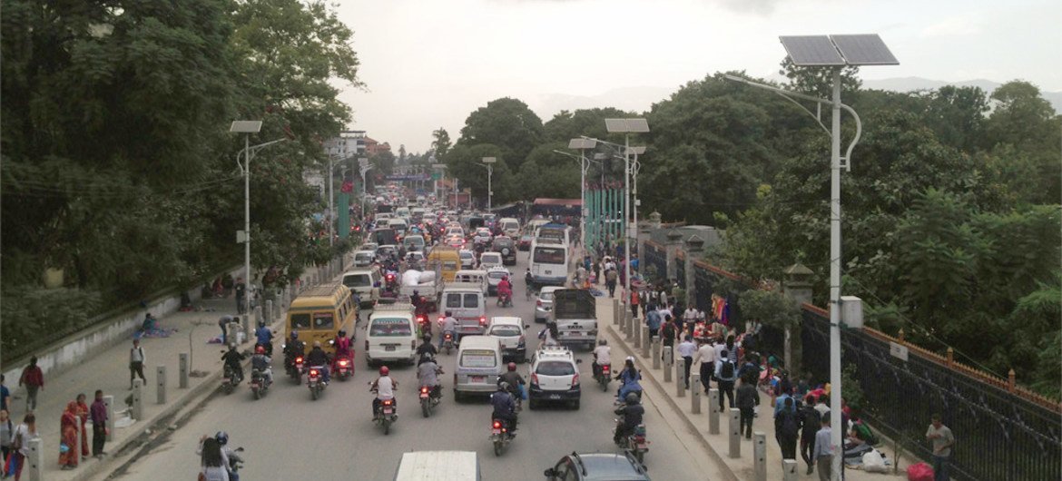 Solar-powered lights line a busy street in Kathmandu, the capital of Nepal.