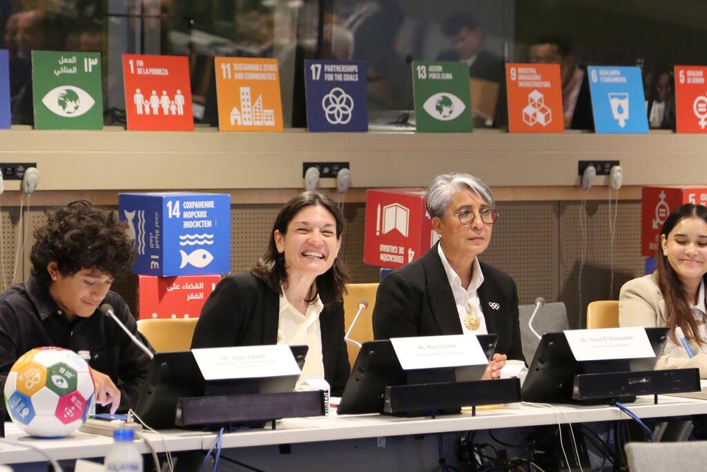 Mary Connor (2nd from left) and Nawal El Moutawakal speaking at a panel discussion at UN Headquarters. The background features the Sustainable Development Goals (SDGs) banners.